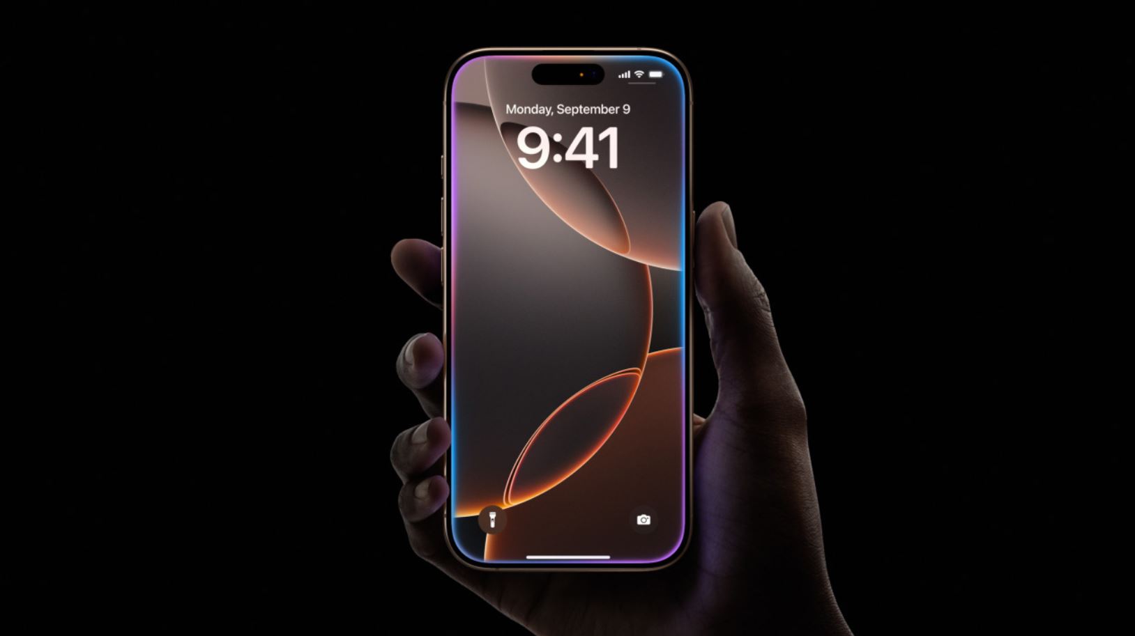 iPhone 16 Pro Max с включённым экраном на чёрном фоне